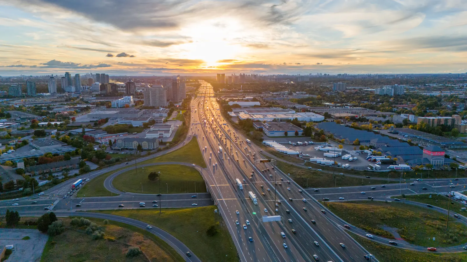 A busy highway interchange at sunset, seen from above